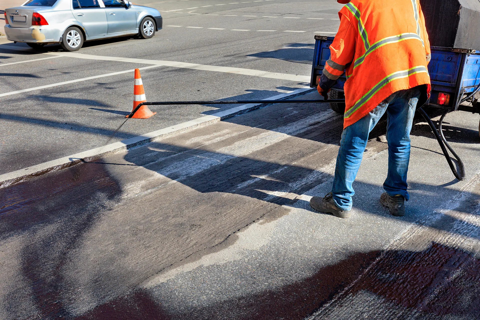 road maintenance worker sprays the bituminous mixt 2023 11 27 05 28 39 utc